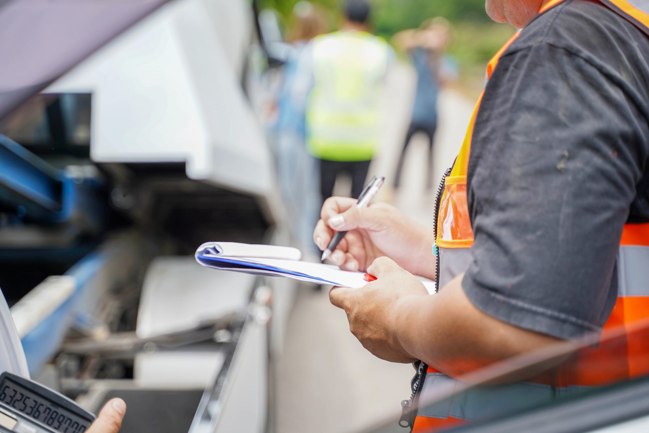 man with clipboard at scene of accident